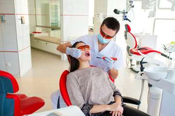 Wall Mural - Filling teeth in a girl in dentistry.