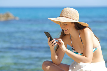 Poster - Happy sunbather using smart phone on the beach