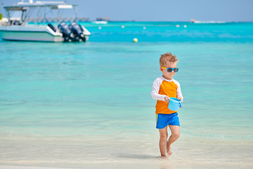 Three year old toddler playing on beach