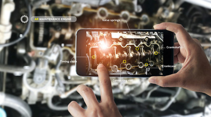 Fototapete - Augmented reality concept. AR. Industrial 4.0 , Hand of engineer holding mobile smart phone using virtual AR to check the work of electric machine on smart factory background.