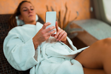 Wall Mural - Woman Relaxing on a Warm Tepidarium Bed in Spa Center.