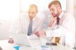© BillionPhotos.com - Portrait of Two businessmen working with laptop in the office