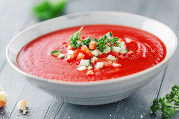 Tasty summer tomato soup served in bowl