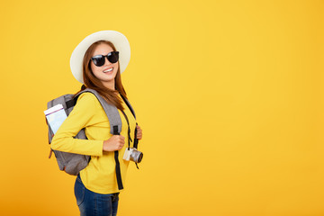 Beautiful traveler asian woman with camera on yellow background ,summer,travel concept.