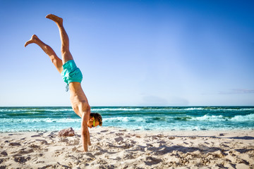 Canvas Print - Young men on beach and sport time. Summer time and free space for your decoration. 