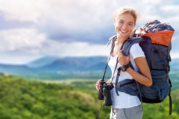 woman with backpack trekking through the wilderness