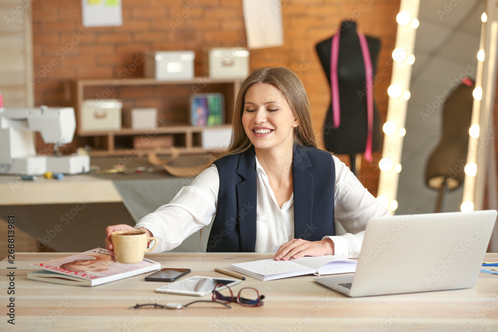 Beautiful female business owner working in atelier