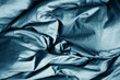 Gray fabric. Crumpled bedding. Background. Texture. Soft focus.