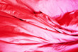 Pink fabric. Crumpled bedding. Background. Texture. Soft focus.