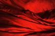 Red fabric. Wrinkled bedding. Passion. Background. Texture. Soft focus.