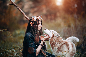 beautiful elf woman fabulous, fairy forest, famtasy young woman with long ears, long dark hair golden wreath crown on head with red dog like wolf