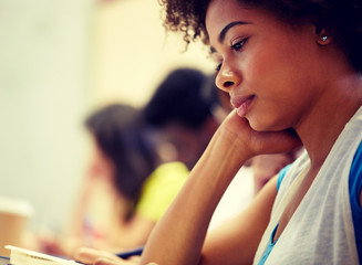 Canvas Print - education, high school, university, learning and people concept - close up of african student girl on lecture