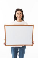 Wall Mural - Happy young woman standing isolated over white