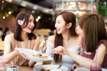 group of happy friends having dinner in the restaurant