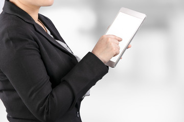 Poster - close up of a business woman working on tablet with clipping path on white screen for easy replace you design on tablet screen