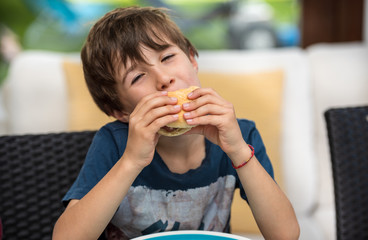 child eating a hamburger