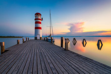 Lighthouse At Lake Neusiedl, Podersdorf Am See, Burgenland, Austria. Lighthouse At Sunset In Austria. Wooden Pier With Lighthouse In Podersdorf On Lake Neusiedl In Austria.