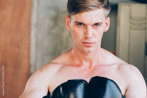 Closeup Of Young Caucasian Male Boxer Wearing Boxing Gloves