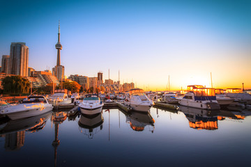 Wall Mural - View of harbor in a yacht club at Toronto city during sunset with Canadian tower as background