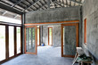 © Silk And Salt Images/Stocksy - Empty interior of an unfinished concrete and wood home under construction