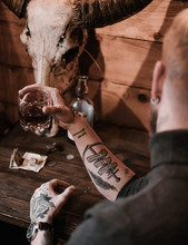 Close Up Of Black Style Tattoo On Anonymous Man Drinking Whiskey