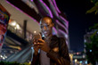 © Jovo Jovanovic/Stocksy - Night portrait of a woman smiling at her phone
