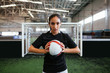 © Bonninstudio/Stocksy - Female soccer player in indoor football.