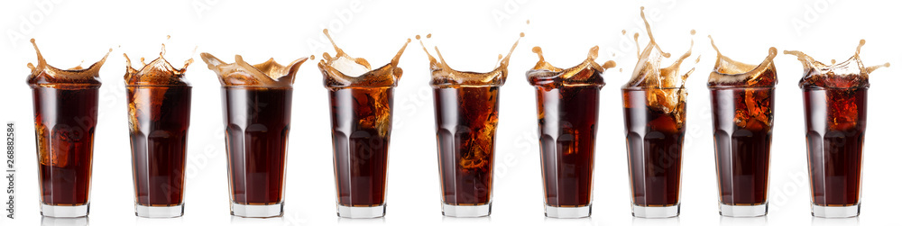 Splash of cola in a glass - obrazy, fototapety, plakaty 