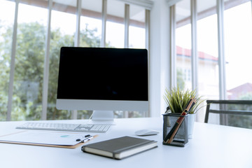 Fototapete - Modern white desk work table with computer laptop and stationary in home office