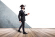 © alesmunt - businessman in virtual reality glasses walking  in an empty room