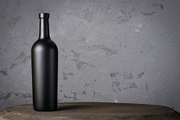 Wall Mural - Red wine bottle on a wooden background