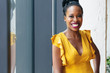 © Gerald Carter/Creative Flame - Portrait of smiling businesswoman in yellow dress