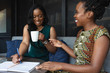 © Gerald Carter/Creative Flame - Smiling businesswomen sit in meeting