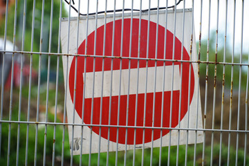 Wall Mural - Stop Warning Sign at Wire Fence Wall