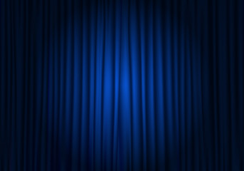 spotlight on stage curtain. closed blue curtain background. theatrical drapes.