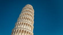 Tourists Sightseeing At The Leaning Tower Of Pisa In Italy