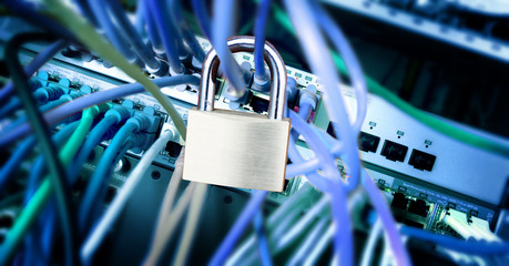 padlock on the cables at a network server, safety concept, color effect