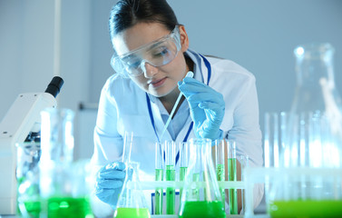 Poster - Female scientist working with sample in modern chemistry laboratory