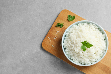 Bowl of delicious rice on table, top view with space for text