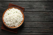 © New Africa - Plate of tasty cooked rice on wooden background, top view. Space for text