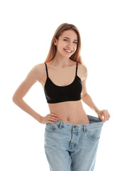 Wall Mural - Slim woman in oversized jeans on white background. Perfect body