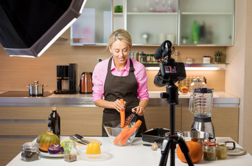 Woman filming cooking vlog. Concept of vlogging, blogging and content creation.