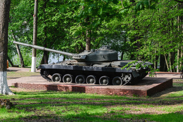 Monument to Russian tank in the summer park. Historical monument.