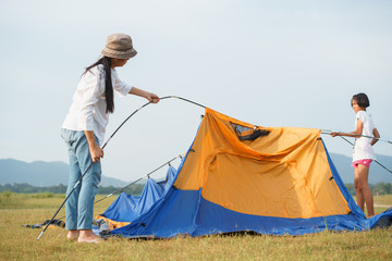 asian families with mothers and children traveling to relax, being a tent for relaxation, the concep
