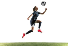 Young Female Football Or Soccer Player With Long Hair In Sportwear And Boots Kicking Ball For The Goal In Jump Isolated On White Background. Concept Of Healthy Lifestyle, Professional Sport, Hobby.
