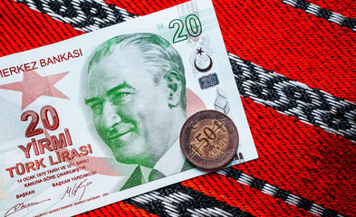 Wall Mural - Turk money, metal coin and banknote. Turkish lira currency with Mustafa Kemal Ataturk portrait. Finance, banking and business in Turkey concept. Traditional ottoman red tablecloth background.