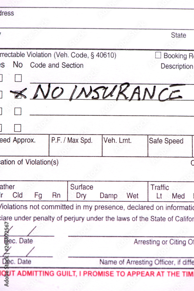 A close up of a traffic ticket with the words “No Insurance