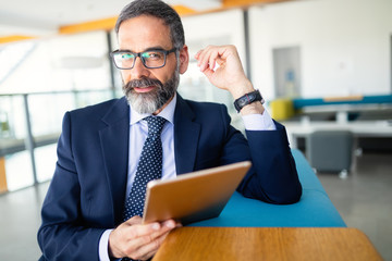 Wall Mural - Confident senior businessman leader working in office