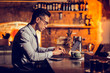 © Viacheslav Yakobchuk - Businessman working remotely sitting at the bar stand
