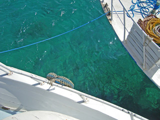 Clean sea water photo between two boats. Sea trip on the yacht.